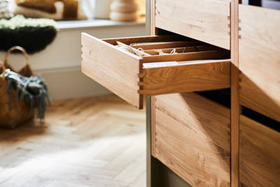 Opened oak drawer with oak inserts in Nordic Craft cabinetry in Magnet customer Jen's kitchen.