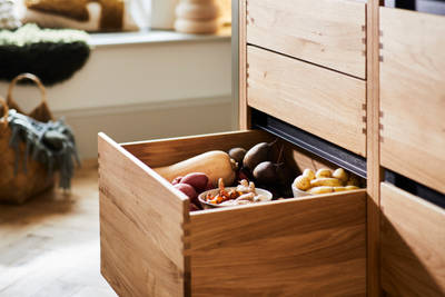 Opened large lower drawer in Nordic Craft cabinet, filled with fresh vegetables.