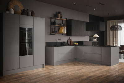 A wide-angle view of an open plan Duxbury kitchen with black appliances, dark worktops and open shelving with earthy accents.