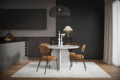 Modern Duxbury kitchen cabinets in Fawn are incorporated into a dining room set up, with functional wine rack integration, dark worktops and wooden accents.