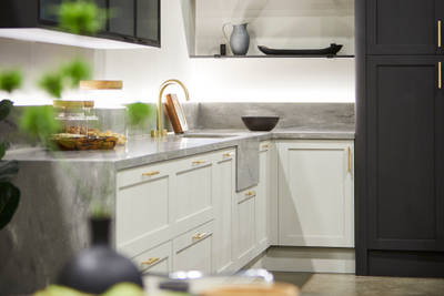 The Ambleside kitchen in Limestone and Graphite, showing full-height doors, drawer frontals and open shelving.
