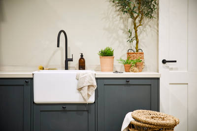 Magnet's Ambleside kitchen in Fern, a dark shade of green. Fitted with a butler's sink and matt black tap.