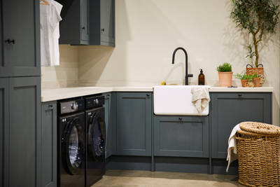 Magnet's Ambleside kitchen, fitted with a butler's sink, matt black tap and black appliances.