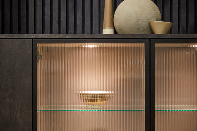 Elegant fluted glass cabinets, shown with contemporary dark wood panelling and modern Portobello kitchen cabinets in Etna.