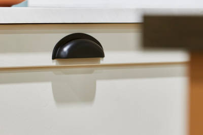 Close-up of black traditional style handle in the shaker kitchen