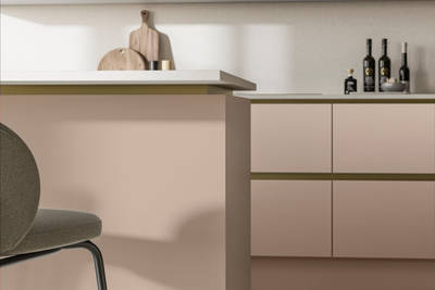 Modern and minimalist Integra Soho Chalk Blush kitchen, a frameless slab door with integrated handles in a smooth paint finish.