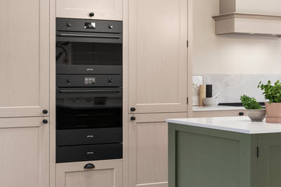 Traditional Shaker-style kitchen range Ludlow with tactile woodgrain in neutral shade Shell with a green Thyme kitchen island.