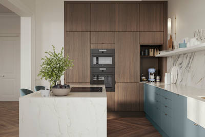 Soho Duck Blue kitchen from Magnet combined with ovens integrated into tall Nordic Nature cabinetry, white marble splashblack, paired beautifully with a bright brass tap and sink.