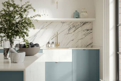 Soho Duck Blue kitchen from Magnet with white marble splashblack, paired beautifully with a bright brass tap and sink.