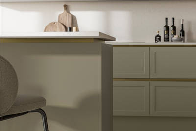 Integra Dunham French Clay, a handleless shaker frontal with brass details and a white worktop..