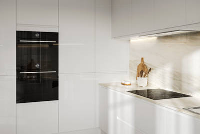 Handleless white gloss Luna kitchen from Magnet, with built-in ovens in tall cabinets.