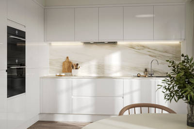 Handleless white gloss Luna kitchen from Magnet, with a white marbled worktop and backsplash.