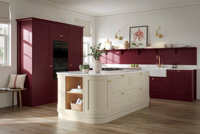 Traditional Shaker-style tactile woodgrain Ludlow kitchen in bold shade Morello with matching wall panel and shelves, brass accents such as knobs and brass tap, a white ceramic sink, Ludlow parchment kitchen island with open end shelves and dusty oak vinyl flooring.