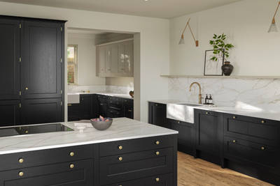 Traditional Shaker-style tactile woodgrain Ludlow Sumi Black kitchen with kitchen island, light and airy with brass accessories, marbled white and grey worktop, Ludlow French Clay wall cabinets and Amtico oak stripwood vinyl flooring.