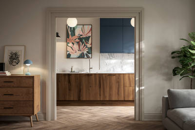 View from living room of Portobello Umbra kitchen cabinets with white compact laminate worktop and splashback, Ascoli Mineral Blue wall cabinets and amtico smouldered oak herringbone flooring.