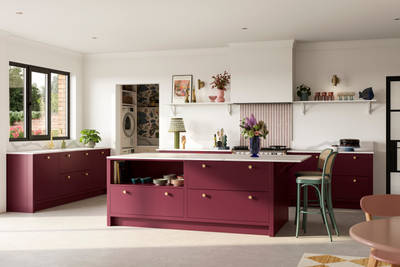 Modern slab front Soho Morello kitchen, kitchen island with rattan bar stools at breakfast bar, Bianco calacatta worktop and upstand, brass knobs and open shelf in kitchen island holding eclectic eramics, utility room with matching Soho cabinetry in the shade  Shell.