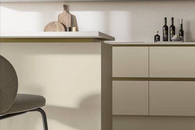 Modern and minimalist Integra Soho Parchment kitchen, a frameless slab door with integrated handles in a smooth paint finish.