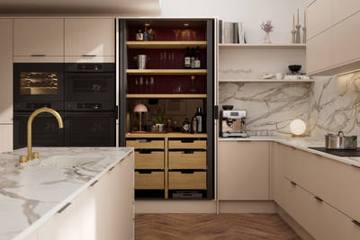 Fluted front kitchen Reed from Magnet in light warm neutral shade Shell, with a marbled splashback and worktop, opened pocket larder cabinet, black handles
