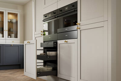 Contemporary Shaker kitchen Ambleside from Magnet in deep blue shade Lake, beige tall cabinets with ovens, brass knobs