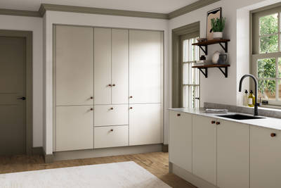 Modern slab kitchen Ascoli in neutral shade Limestone with brass knobs and black tap