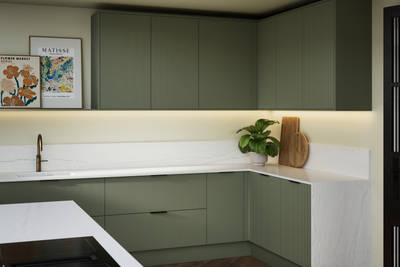 Green fluted kitchen fronts on kitchen cabinets with black handles, white marble worktop, upstand and matching decorative sides.