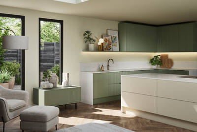 Green fluted kitchen fronts on tall cabinets with built-in appliances and black handles, light neutral shade handleless kitchen island and green sideboard on metal legs.