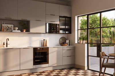 Angled view of modern slab front Soho Cornish Clay kitchen from Magnet in Pantone’s colour of the year ‘Mocha Mousse’ with bronze trim handles, handles, silestone quartz worktop and matching backsplash, checkered flooring.