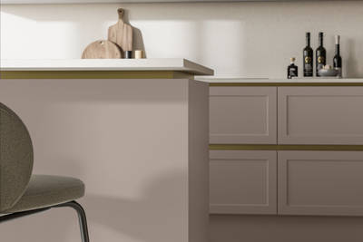 Integra Dunham Cornish Clay, a handleless shaker frontal with brass details and a white worktop.