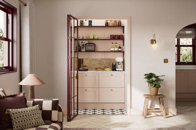 View of coffee bar in walk-in pantry with glass doors, painted wood grain Shaker style Bewdley kitchen with cabinets in light pink shade Chalk Blush, marbled worktop.