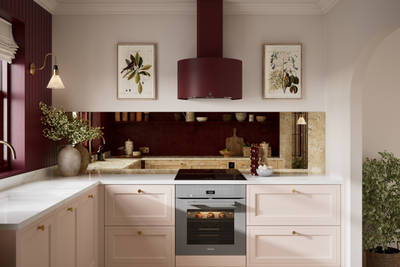 Painted wood grain Shaker style Bewdley kitchen with cabinets in light pink shade Chalk Blush, marbled worktop, brass knobs and copper toned mirror splashback.