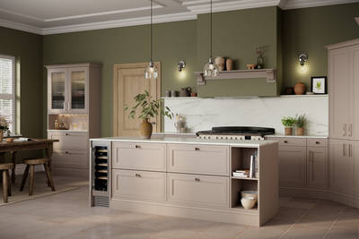 Shaker style painted wood grain Bewdley kitchen in neutral shade Cornish Clay, tall cabinets and kitchen island with marbled worktop and matching backsplash, wine cooler in the kitchen island and gas range cooker.