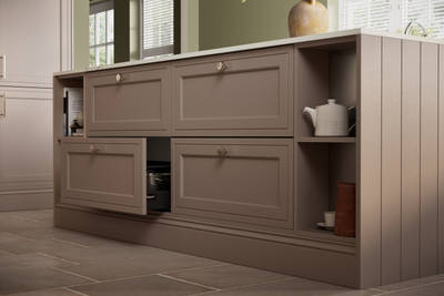Close-up view of Shaker style painted wood grain Bewdley cabinet kitchen island with classic design steel knobs, open shelves and decorative splinth matching the Cornish Clay shade.