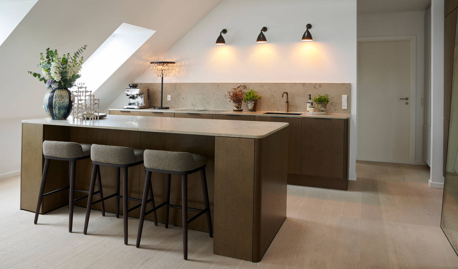 Forever Oak køkken med ø, mørkt træ fronter, marmor bordplade og bagplade, sort vask og messing armatur