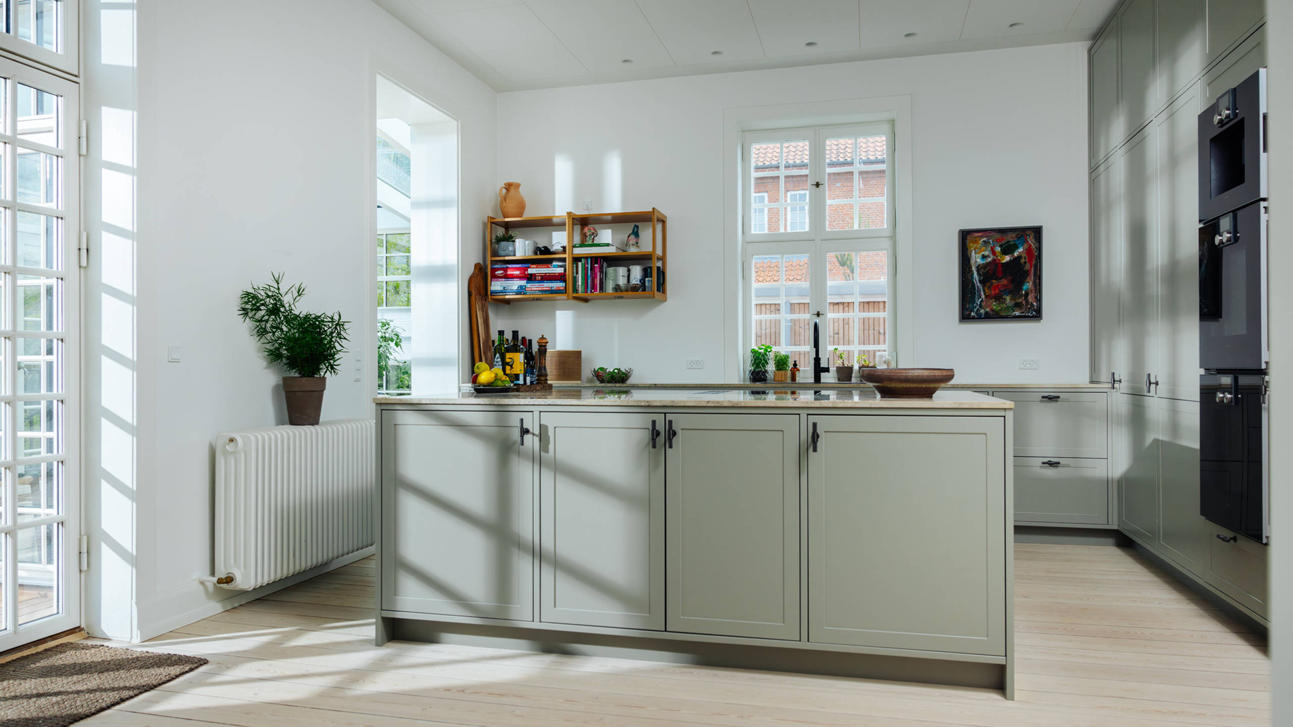 The stone grey Shaker kitchen with the Jura Polar Blau worktop is a beautiful match for the home built 1923.