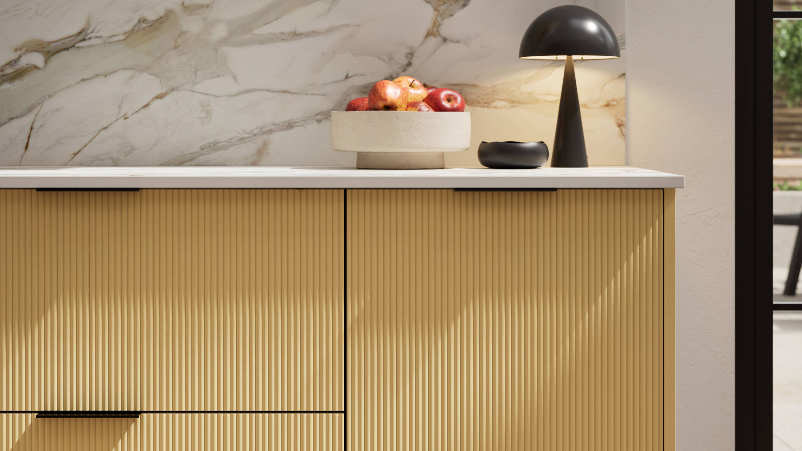 Fluted front kitchen Reed from Magnet in bright yellow shade Harvest, with a marbled splashback and black handles, herringbone wood flooring.
