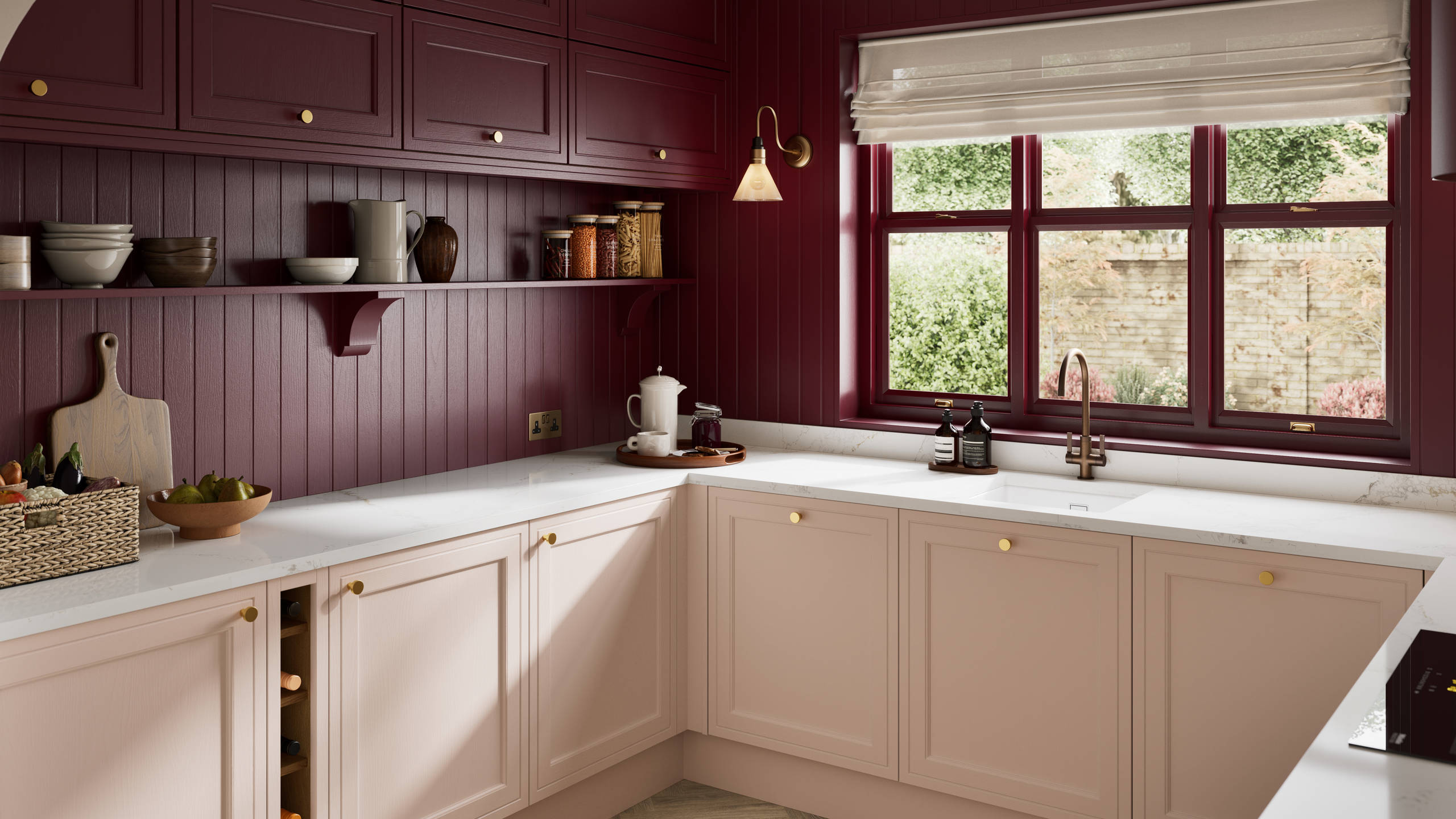 Painted wood grain Shaker style Bewdley kitchen with cabinets in light pink shade Chalk Blush, marbled worktop, brass knobs, red Morello wall-mounted cabinets with matching shelves and wall panel, built- in wine storage.