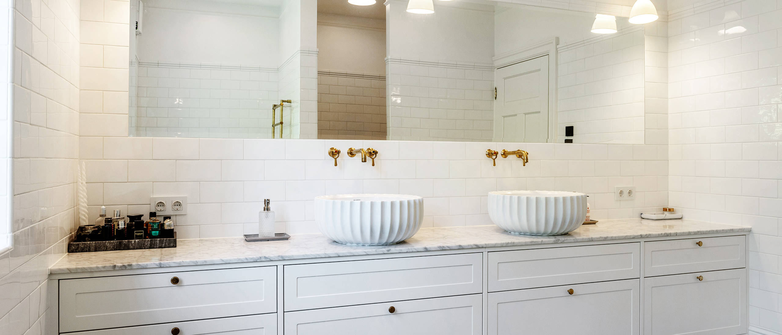 White master bathroom with subway tiles, brass fittings and handmade Made a Mano tiles