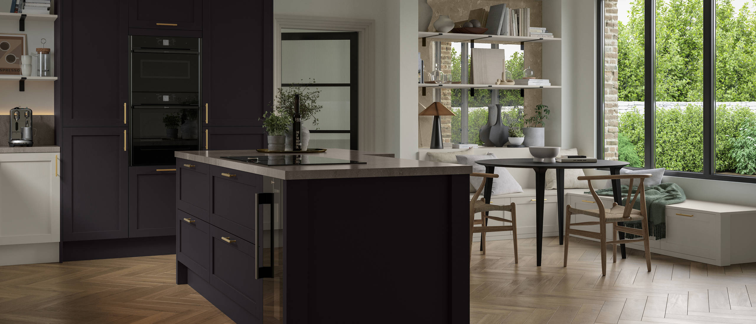 The Ambleside kitchen in a dark Graphite shade, in a contemporary kitchen setting with wooden herringbone flooring.