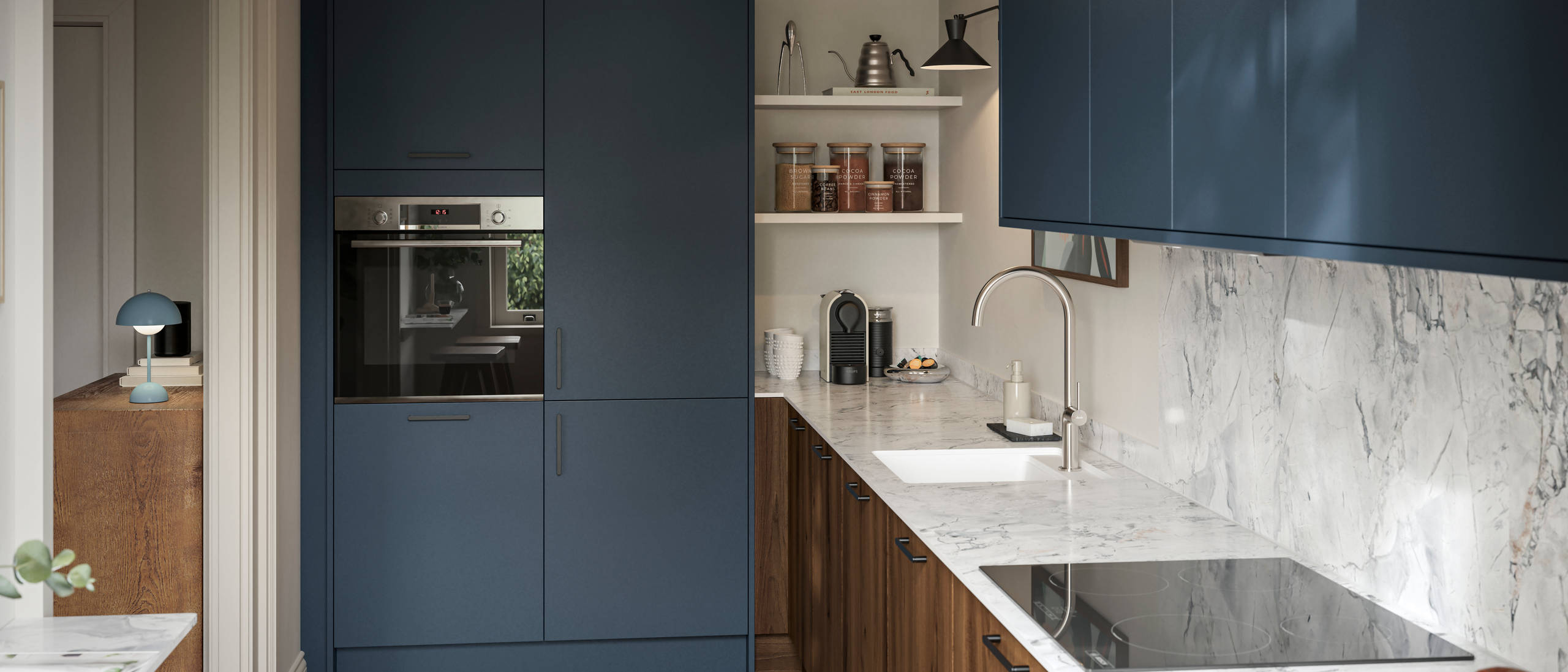Contemporary Ascoli Mineral Blue tall cabinets and wall cabinets over Portobello Umbra kitchen cabinets with marbled compact laminate worktop, black handles and Amtico smouldered oak herringbone flooring.