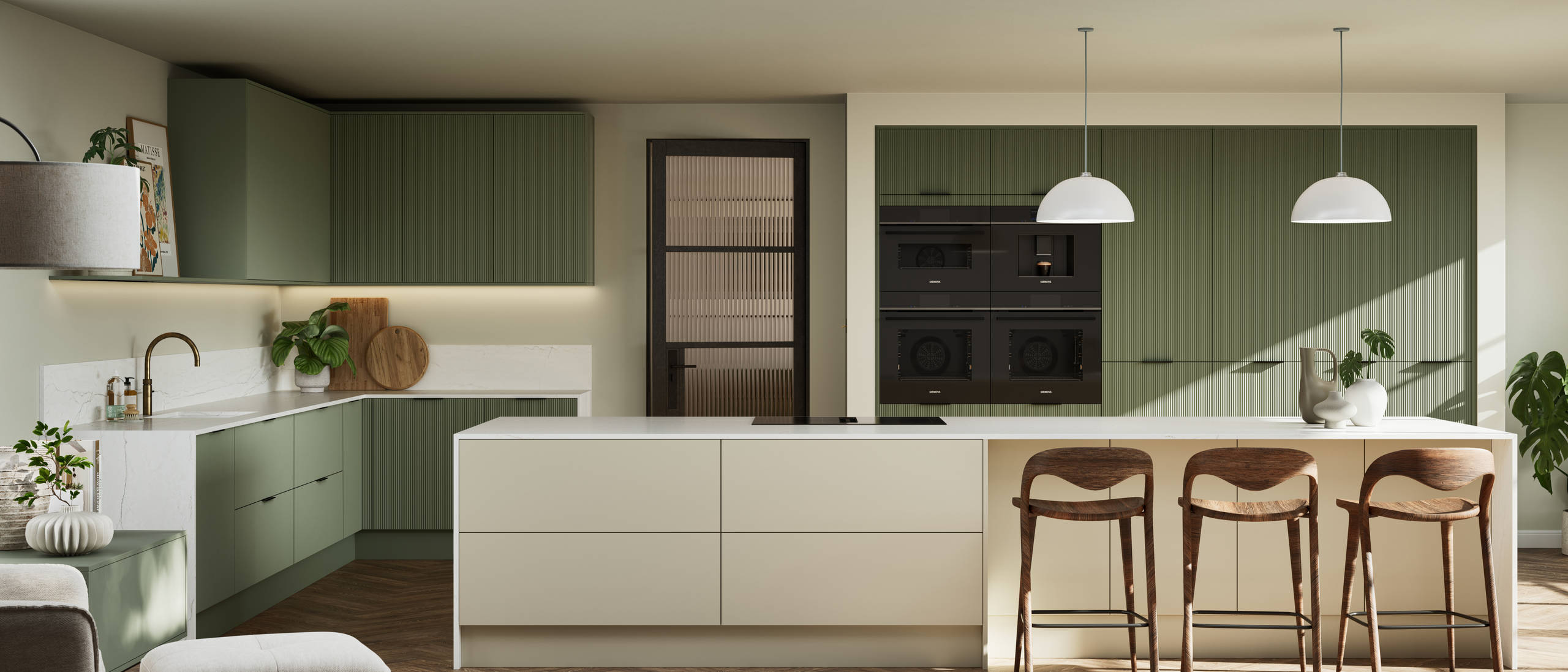 Green fluted kitchen fronts on tall cabinets with built-in appliances and black handles, light neutral shade kitchen island with white worktop and wooden barstools.