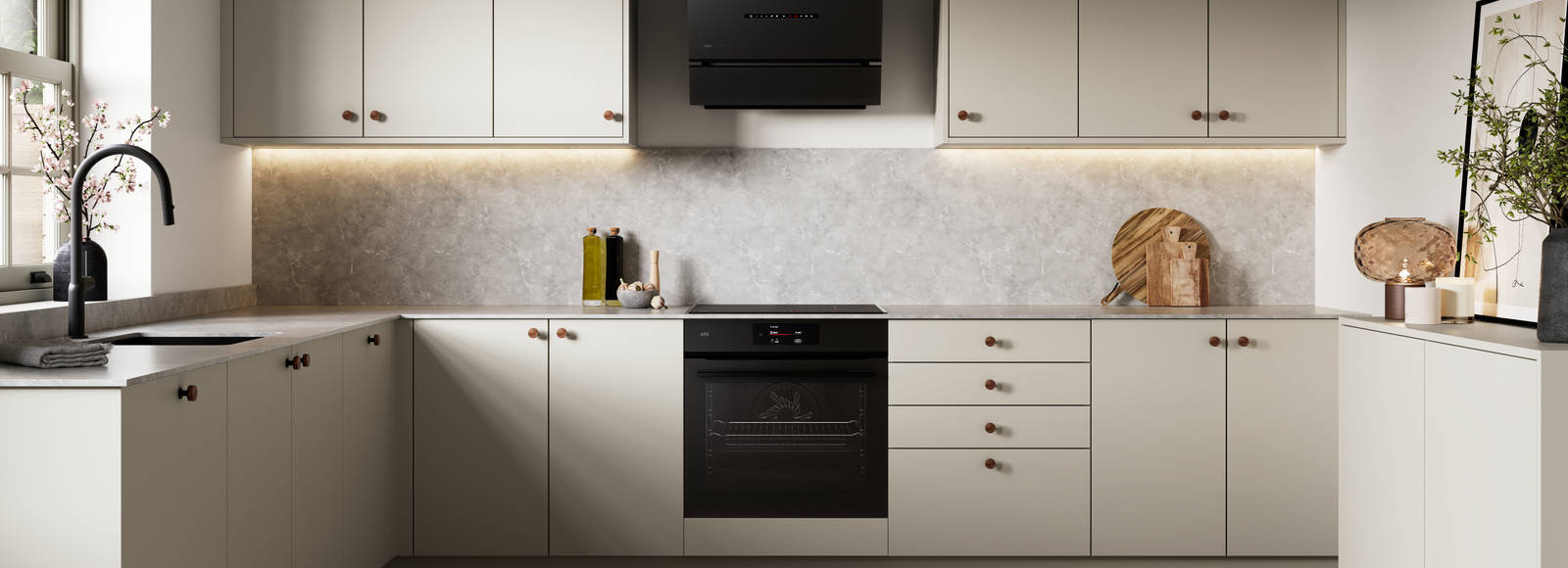 Modern slab kitchen Ascoli in neutral shade Limestone with brass knobs and black tap
