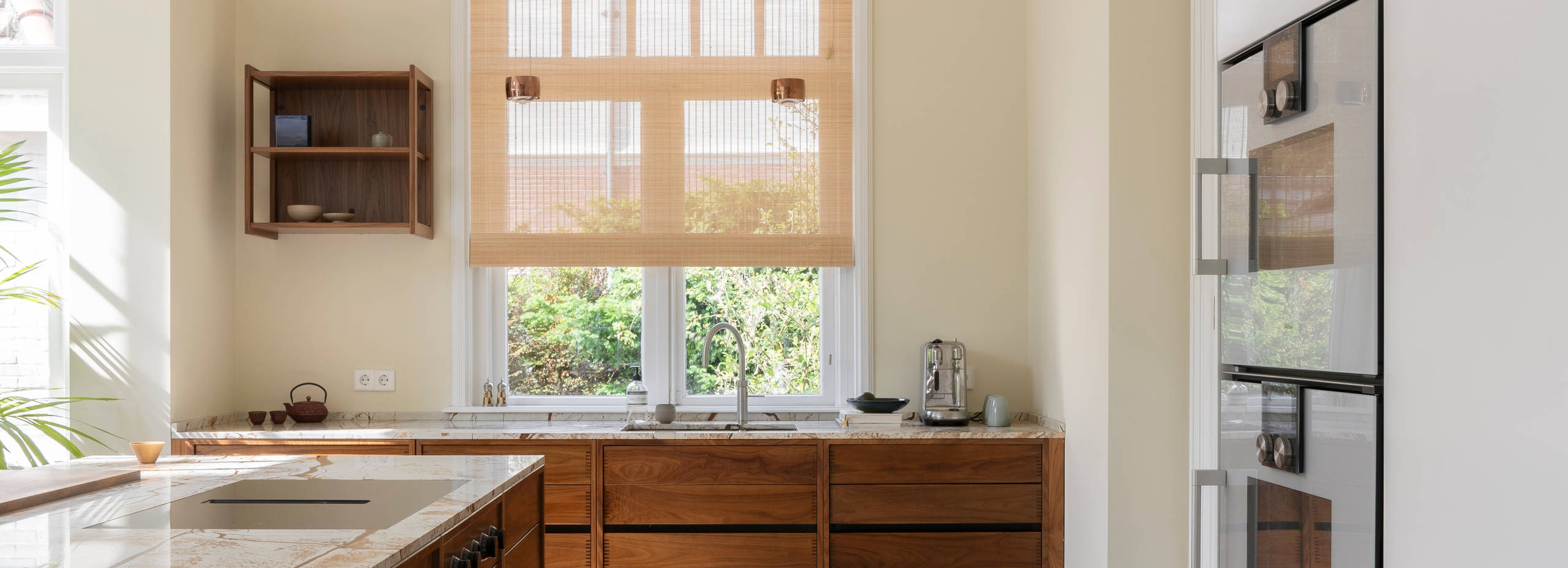 uno form custom-made kitchen in walnut with tall cabinets in Glacier White
