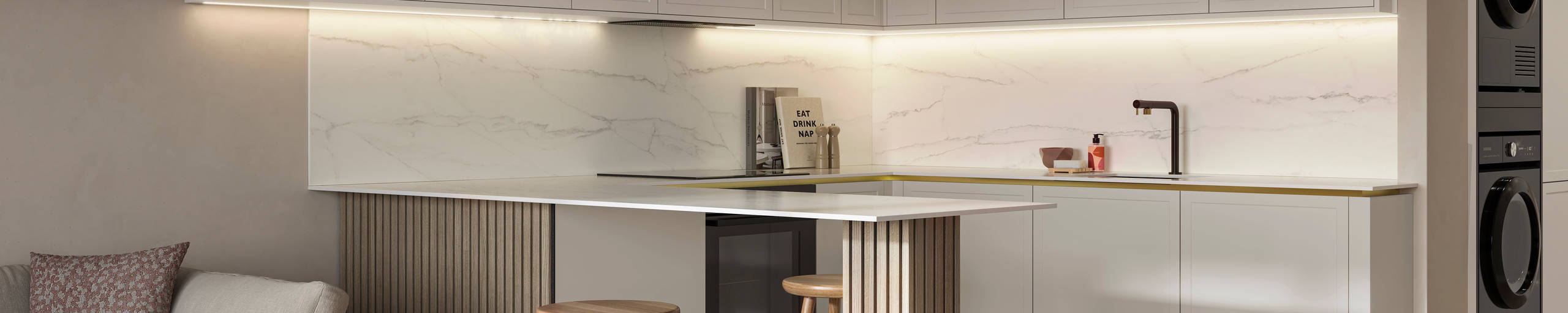 Handleless Wabi sabi inspired Integra Brunswick Limestone kitchen combined with living area, wood barstools for breakfast bar, natural materials, Euros oak flooring.