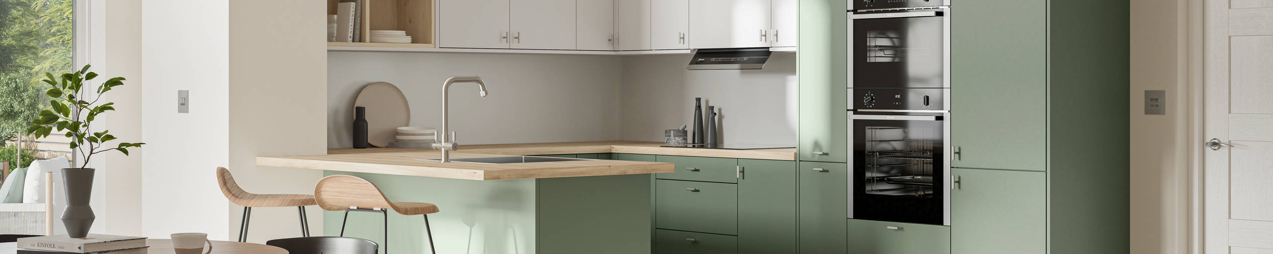 Contemporary scandinavian influenced Ascoli kitchen in fresh shade green Woodland and light grey, wall cabinets with timber accents like open shelves and oak laminate worktop, matched with oak laminate flooring and wood barstools at breakfast bar.