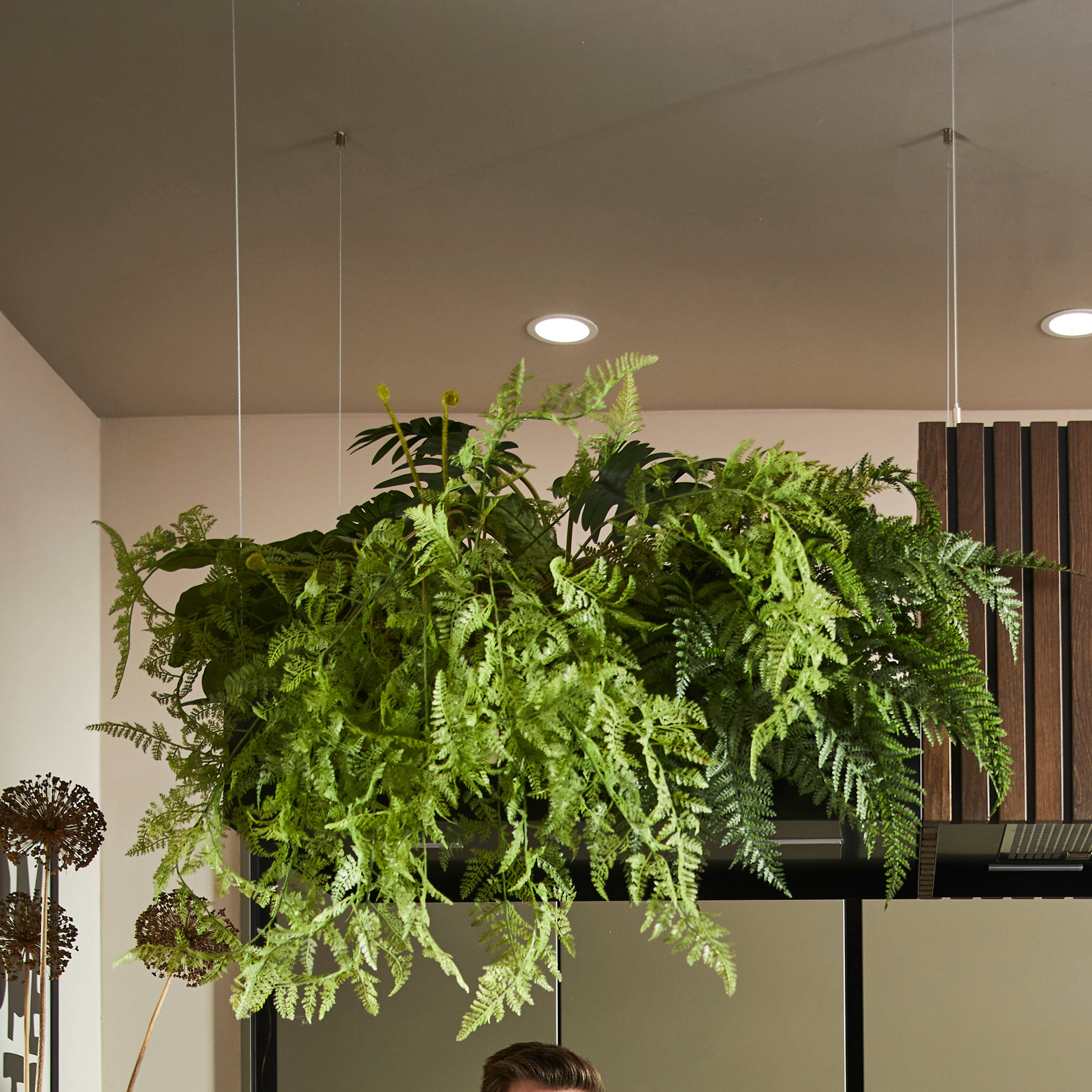 Ally and James Dowsing-Reynolds posing in their kitchen along with Jen Nash from Magnet