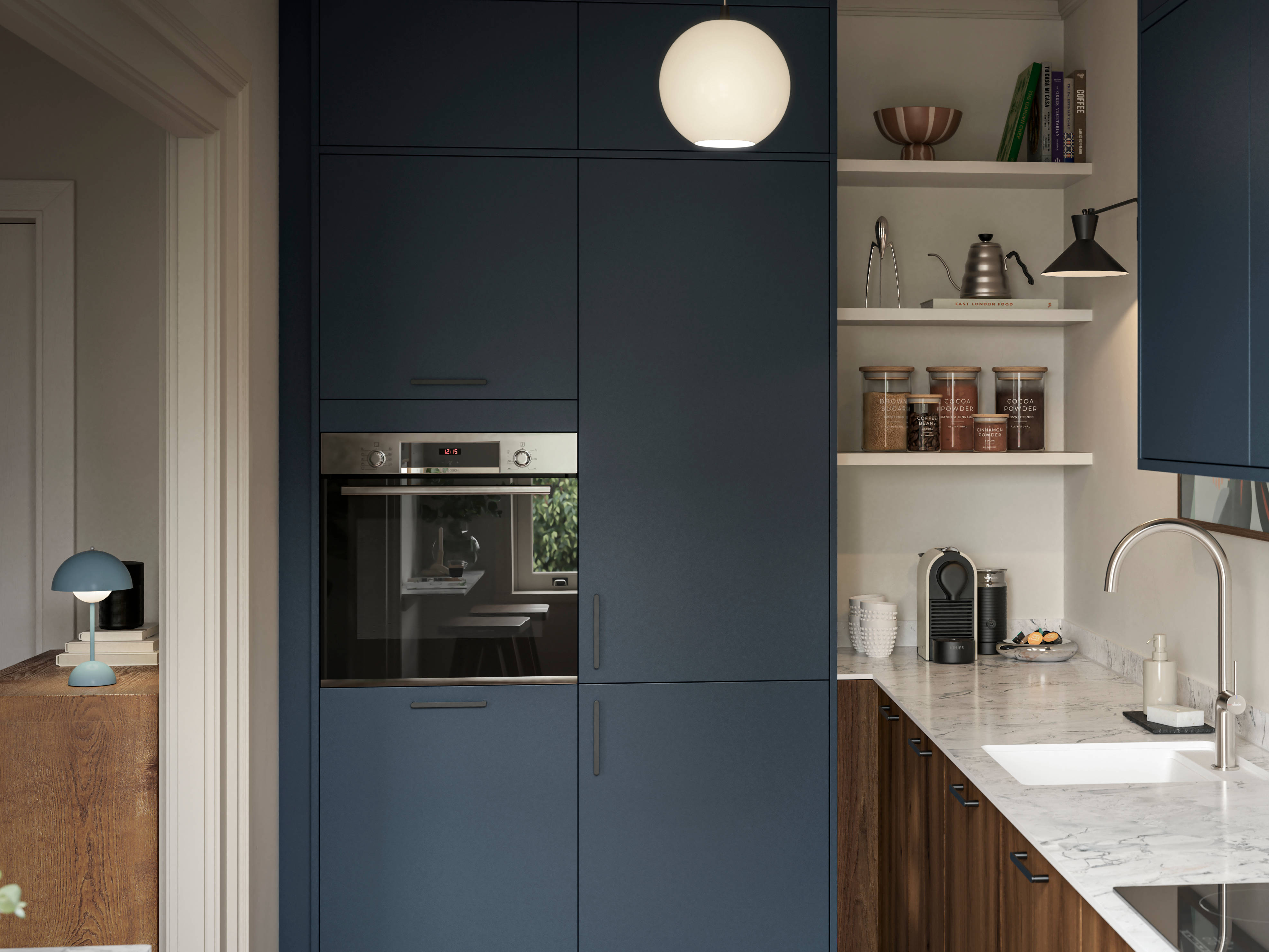 Contemporary Ascoli Mineral Blue tall cabinets and wall cabinets over Portobello Umbra kitchen cabinets with marbled compact laminate worktop, black handles and Amtico smouldered oak herringbone flooring.