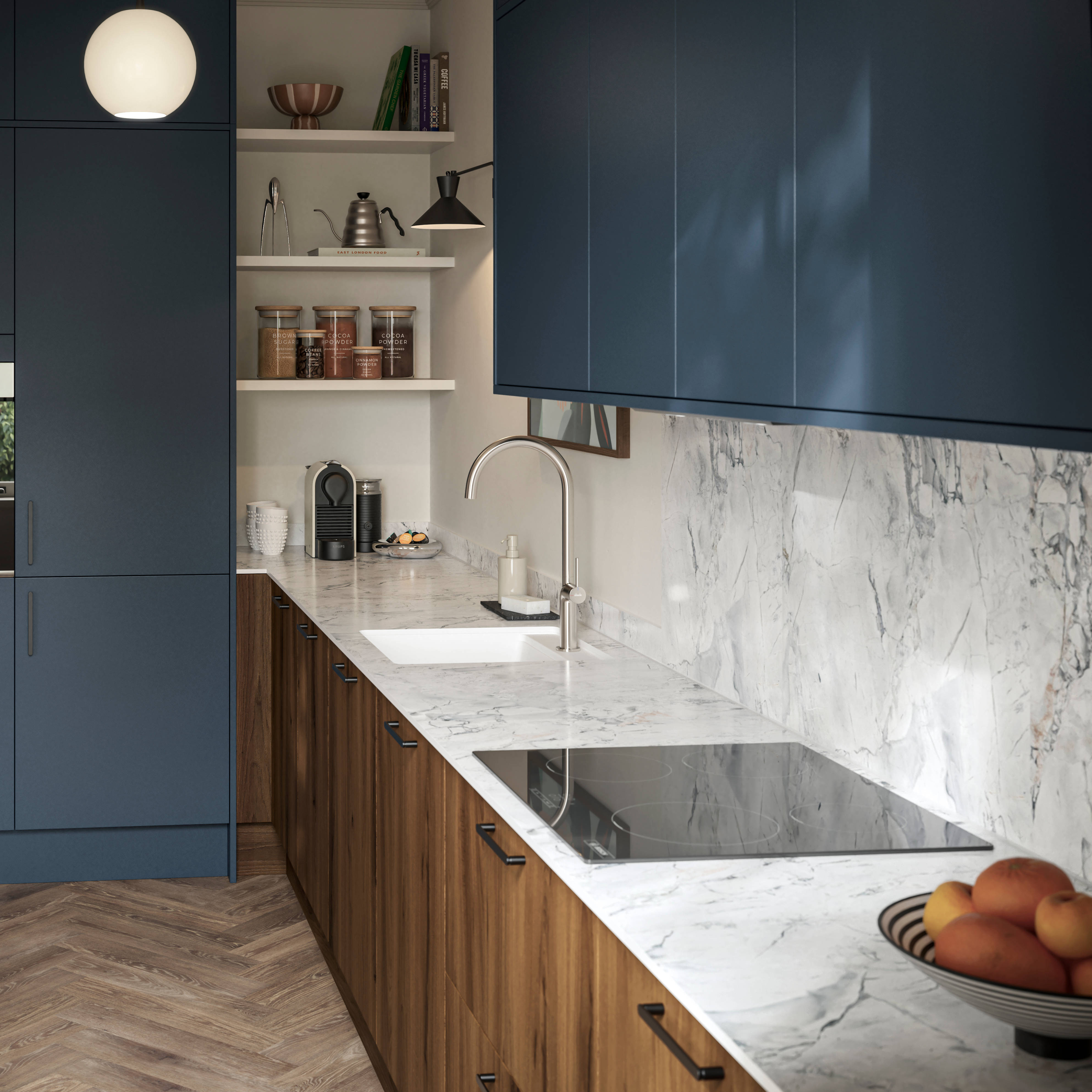Contemporary Ascoli Mineral Blue tall cabinets and wall cabinets over Portobello Umbra kitchen cabinets with marbled compact laminate worktop, black handles and Amtico smouldered oak herringbone flooring.