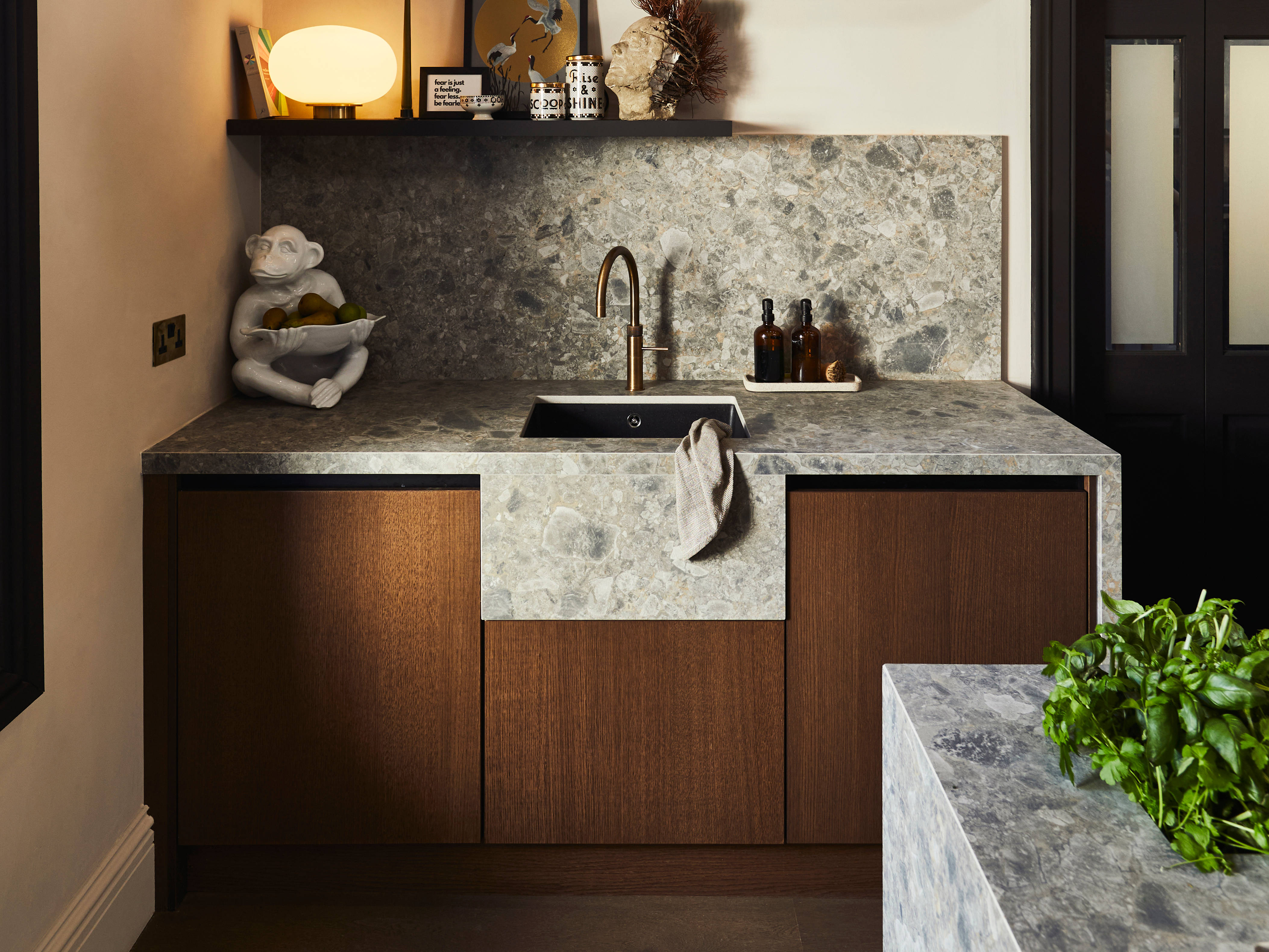 Sink area with Dekton in Ceppo backsplash and worktop, Nordic Nature cabinetry and a brass Quooker tap.