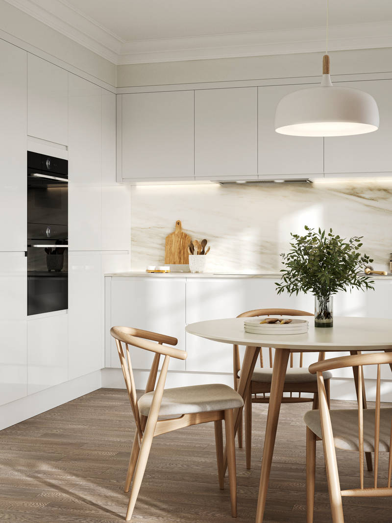 Handleless white gloss Luna kitchen from Magnet, light wood kitchen table with matching chairs and plants