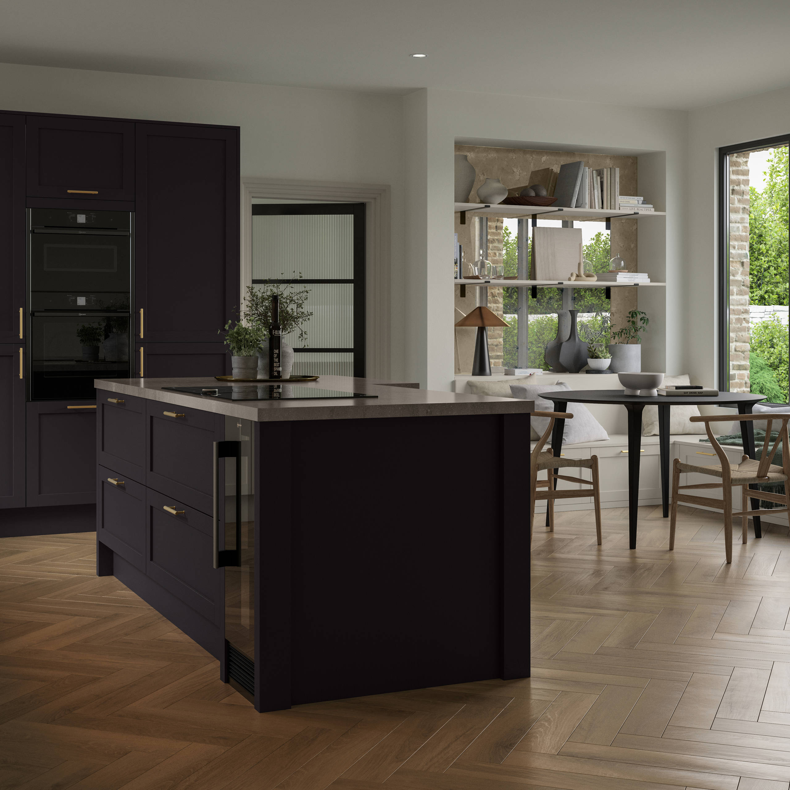 The Ambleside kitchen in a dark Graphite shade, in a contemporary kitchen setting with wooden herringbone flooring.